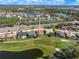 Scenic aerial view of a residential community with golf course and lake at 5080 Kilty E Ct, Bradenton, FL 34203