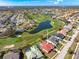 Expansive aerial view of a residential area featuring a golf course, lakes, and well-maintained homes at 5080 Kilty E Ct, Bradenton, FL 34203