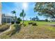 Expansive backyard showcasing a manicured lawn, mature trees, and a screened-in pool, ideal for outdoor activities at 5080 Kilty E Ct, Bradenton, FL 34203