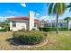 Well-maintained backyard featuring a red tile roof, manicured bushes, and a screened-in pool, great for outdoor enjoyment at 5080 Kilty E Ct, Bradenton, FL 34203