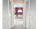 Hallway view of a bathroom with a luxurious soaking tub and elegant finishes at 5080 Kilty E Ct, Bradenton, FL 34203