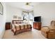 Bedroom with a TV, sitting chair, and corner windows for natural light at 5080 Kilty E Ct, Bradenton, FL 34203