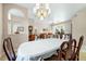 Spacious dining room with traditional wood furniture leads to living area at 5080 Kilty E Ct, Bradenton, FL 34203