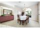 Traditional dining room features carpet, chandelier, and built-in cabinet with mirror at 5080 Kilty E Ct, Bradenton, FL 34203