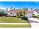 Charming single-story home with a red tile roof, well-manicured lawn, and mature landscaping at 5080 Kilty E Ct, Bradenton, FL 34203