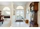 Bright foyer features tiled floors, arched windows, double doors, and decorative accents at 5080 Kilty E Ct, Bradenton, FL 34203