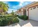 Welcoming single-story home with a red tile roof, arched entryway, and neatly trimmed bushes at 5080 Kilty E Ct, Bradenton, FL 34203