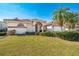 Attractive single-story home boasts a red tile roof, beautiful landscaping, and a manicured lawn at 5080 Kilty E Ct, Bradenton, FL 34203