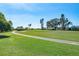 A view of a well manicured golf course with a paved cart path winding through lush green grass at 5080 Kilty E Ct, Bradenton, FL 34203