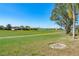 Scenic view of a lush green golf course with a tranquil pond and well-maintained grounds at 5080 Kilty E Ct, Bradenton, FL 34203