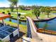 Scenic golf course view with a charming wooden bridge over the water, enhancing the community's appeal at 5080 Kilty E Ct, Bradenton, FL 34203