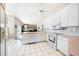 Bright kitchen features white appliances, tile floors, and an open layout at 5080 Kilty E Ct, Bradenton, FL 34203