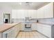 Cozy kitchen with white cabinets, countertops, and tile flooring at 5080 Kilty E Ct, Bradenton, FL 34203