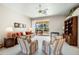 Open-concept living room with natural light, a ceiling fan, and sliding glass doors leading to the pool at 5080 Kilty E Ct, Bradenton, FL 34203