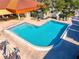 Community swimming pool with lounge chairs, tables, and umbrellas at 5080 Kilty E Ct, Bradenton, FL 34203