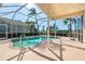 Enjoy the screened in pool with clear blue water, along with a covered patio with a view at 5080 Kilty E Ct, Bradenton, FL 34203