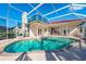 Spacious screened-in pool with brick trim and ample room for outdoor lounging and entertaining on a sunny day at 5080 Kilty E Ct, Bradenton, FL 34203