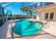 The enclosed pool area features a clear blue pool, spa, and access to the home through patio doors at 5080 Kilty E Ct, Bradenton, FL 34203