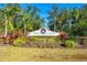 Beautiful Peridia Golf & Country Club sign surrounded by colorful tropical plants at 5080 Kilty E Ct, Bradenton, FL 34203