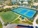 Aerial view of blue and green tennis and pickleball courts with putting green at 5080 Kilty E Ct, Bradenton, FL 34203