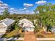 Aerial view of home showcasing the roof, garage, driveway and surrounding yard with mature trees at 538 Fallbrook Dr, Venice, FL 34292