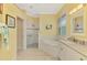 Bright bathroom features tiled walk-in shower, soaking tub, double sink vanity, and natural light from plantation shutters at 538 Fallbrook Dr, Venice, FL 34292