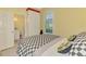 Bedroom features a checkered comforter, hardwood floors, and an ensuite bathroom at 538 Fallbrook Dr, Venice, FL 34292