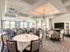 Elegant dining area with round tables, linen tablecloths, and modern chandelier lighting at 538 Fallbrook Dr, Venice, FL 34292