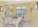 Bright dining room featuring a modern table set and a large window with shutters at 538 Fallbrook Dr, Venice, FL 34292