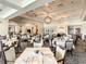 Bright dining room with formal table settings, patterned carpeting, and tasteful wall art at 538 Fallbrook Dr, Venice, FL 34292