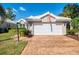 Home exterior with a two-car garage, brick driveway and mature landscaping at 538 Fallbrook Dr, Venice, FL 34292