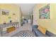 Bright, yellow foyer with light wood floors leading into the home at 538 Fallbrook Dr, Venice, FL 34292