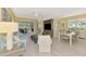 Bright and airy living room featuring hardwood floors, ceiling fan, and sliding glass doors at 538 Fallbrook Dr, Venice, FL 34292