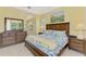 Spacious main bedroom featuring a large bed, elegant furnishings, and serene decor at 538 Fallbrook Dr, Venice, FL 34292