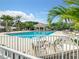 Beautiful swimming pool area surrounded by palm trees and comfortable lounge chairs at 538 Fallbrook Dr, Venice, FL 34292