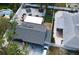 An aerial view shows this house features solar panels, outdoor entertaining space, trampoline, and mature trees at 5419 1St W Ave, Bradenton, FL 34209