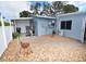 Backyard featuring gravel, stone pavers, air conditioner, and utility access at 5419 1St W Ave, Bradenton, FL 34209