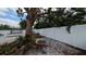 Backyard featuring a colorful swing suspended from a large tree, with a trampoline in the background at 5419 1St W Ave, Bradenton, FL 34209