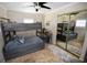 Bedroom with a wooden bunk bed, stylish decor, and a sliding mirror closet at 5419 1St W Ave, Bradenton, FL 34209