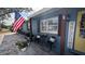 Charming exterior features a welcoming front porch with a seating area, decorated with patriotic American flag at 5419 1St W Ave, Bradenton, FL 34209