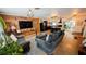 Open-concept living room flowing into the kitchen, featuring wood paneling and modern appliances at 5419 1St W Ave, Bradenton, FL 34209