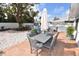 An inviting backyard patio area features gray outdoor furniture and a charming pea gravel area with a large tree for shade at 5419 1St W Ave, Bradenton, FL 34209