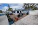 Relaxing patio with a variety of seating options, complemented by lush planters and a view of the well-maintained yard at 5419 1St W Ave, Bradenton, FL 34209