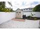 Backyard featuring utility shed, stone ground cover and white privacy fence at 5419 1St W Ave, Bradenton, FL 34209