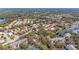 Expansive aerial view of a residential neighborhood featuring mature trees and a community lake at 5513 83Rd E Ter, Sarasota, FL 34243