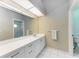 Bathroom with a clean design, featuring a large mirror, ample counter space, and tiled floors at 5513 83Rd E Ter, Sarasota, FL 34243