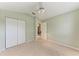 Neutral bedroom with standard closet and a light green accent wall, offering a blank canvas for personal touches at 5513 83Rd E Ter, Sarasota, FL 34243