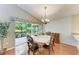 Dining area featuring sliding glass doors to a screened patio and views of the backyard at 5513 83Rd E Ter, Sarasota, FL 34243