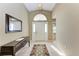 Elegant foyer with tiled floors, decorative rug, mirror, and console table at 5513 83Rd E Ter, Sarasota, FL 34243