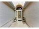 Charming entryway with decorative door, neutral walls, and potted plants creating a warm welcome at 5513 83Rd E Ter, Sarasota, FL 34243